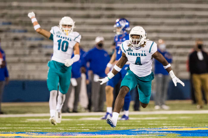 Coastal Carolina players celebrate a play during their win at Kansas.