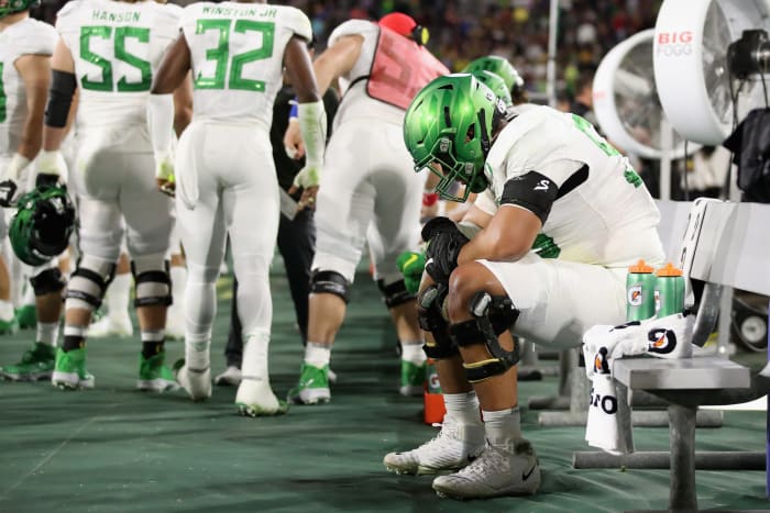 Oregon football star Penei Sewell on the bench during a Pac-12 game vs. Arizona State.