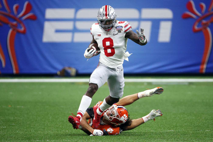 Ohio State running back Trey Sermon runs away from a Clemson defender.