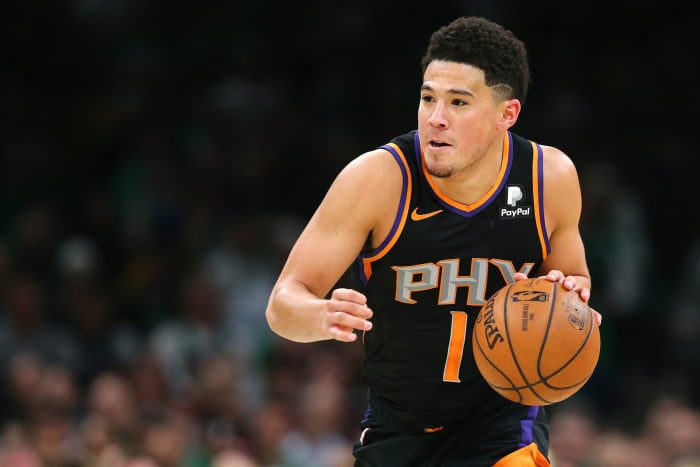 A closeup of Devin Booker dribbling the ball.