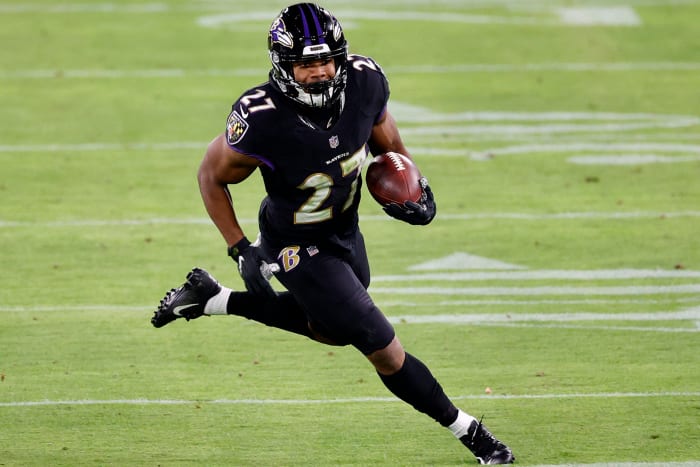 JK Dobbins runs the ball for the Ravens.