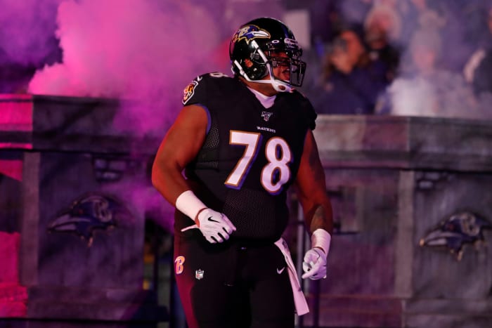 Orlando Brown Jr. walks onto the field.