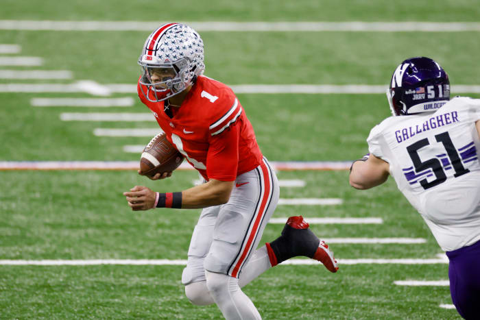 Justin Fields tries to shake a Northwestern defender in the Big Ten title game.