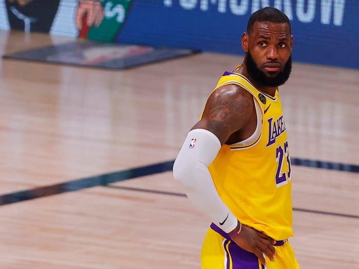 LeBron James looks onto the court against the Nuggets.