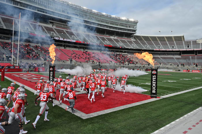 Ohio State players run onto the field before a game in September.