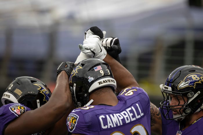 Ravens Calais Campbell in a huddle.