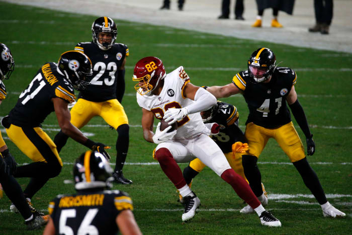 Logan Thomas of the Washington Football Team carries the football and looks to gain yards