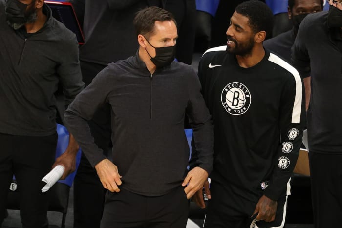 Brooklyn Nets head coach Steve Nash looks on with Kyrie Irving during a preseason game