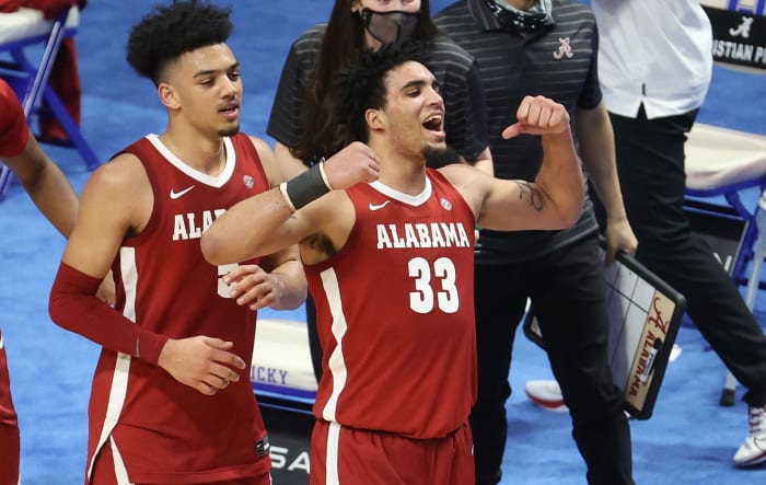 Alabama's James Rojas flexes on the court.