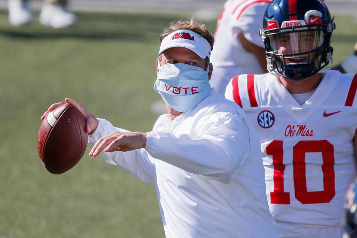 Mississippi head coach Lane Kiffin throws a ball.
