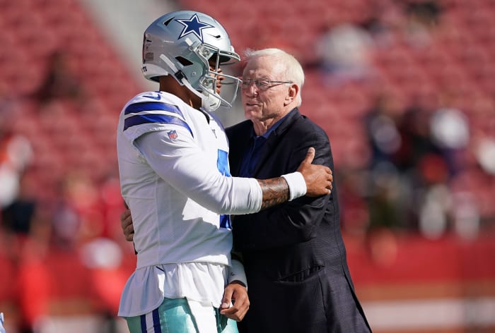 Dak Prescott and Jerry Jones embrace before a Dallas Cowboys game.