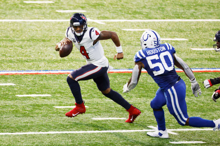 Houston Texans quarterback Deshaun Watson runs away from a defender.