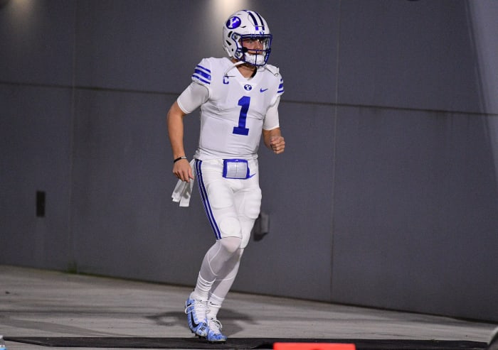 Zach Wilson runs on the field for BYU.