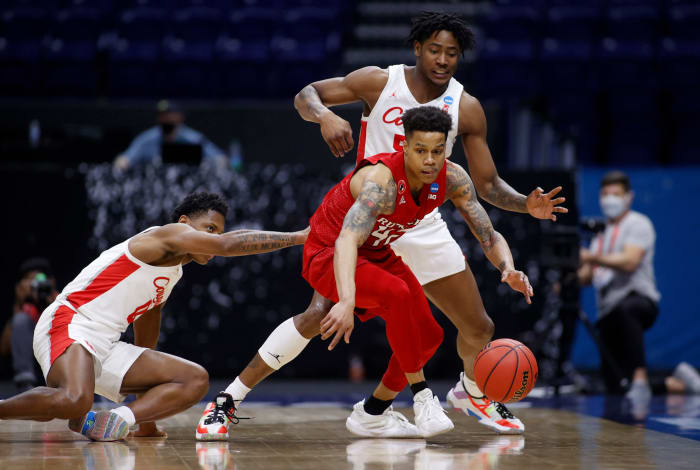 Rutgers' Jacob Young battles with Houston players for a loose ball.