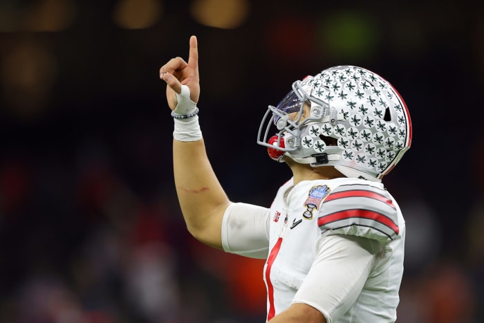 Ohio State quarterback Justin Fields points at the sky.