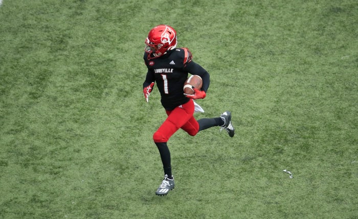 Tutu Atwell runs with the football for the Cardinals.