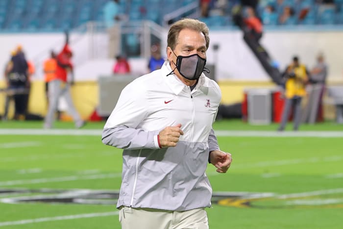Nick Saban runs to the sideline.