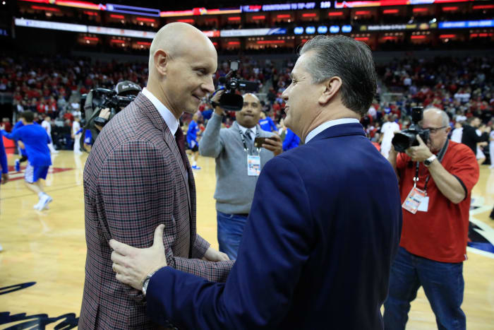 John Calipari and Chris Mack at a Louisville vs. Kentucky basketball game.