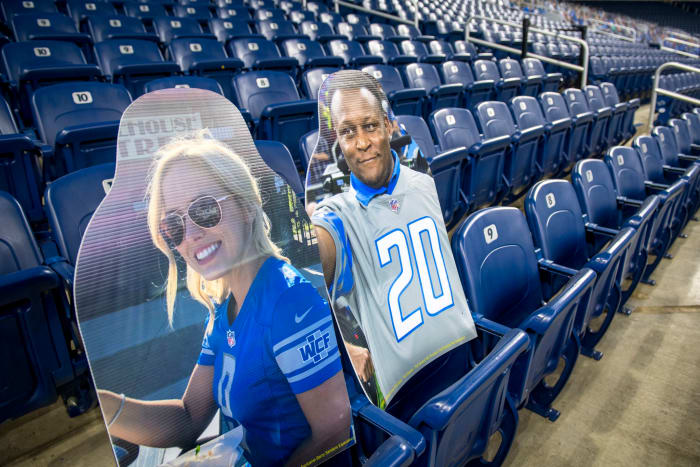 Cutouts of Matthew Stafford's wife Kelly Stafford and Barry Sanders at a Detroit Lions game.