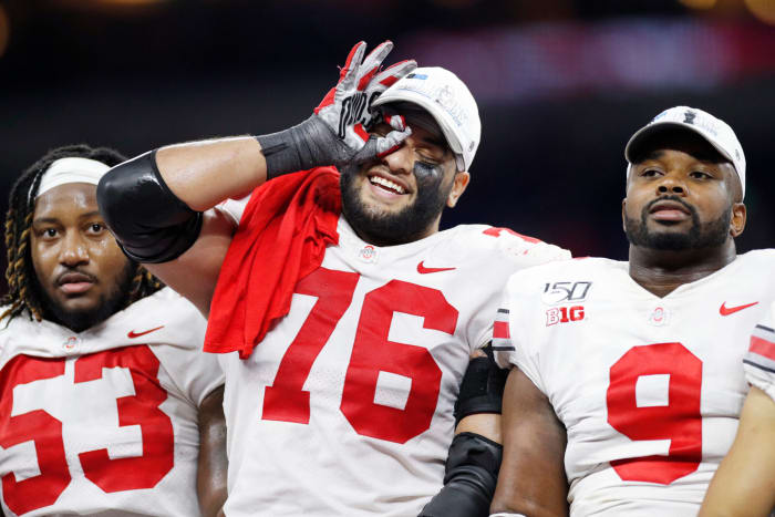 Davon Hamilton #53, Branden Bowen #76 and Jashon Cornell #9 of the Ohio State Buckeyes celebrate after the win against the Wisconsin Badgers in the Big Ten Football Championship