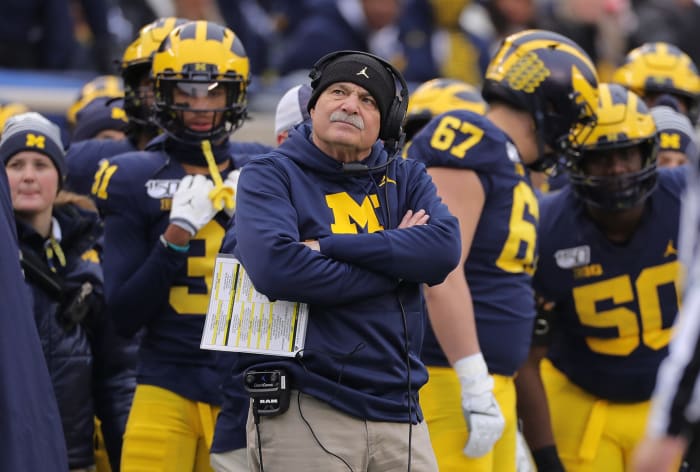 Don Brown looks on from the sideline.