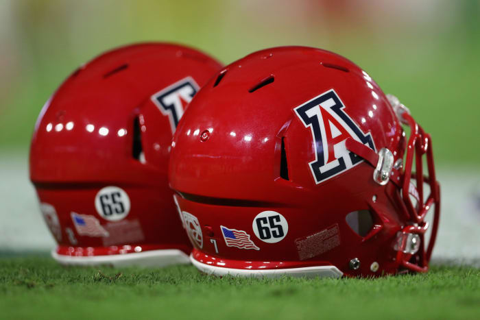 Two Arizona Wildcats football helmets.