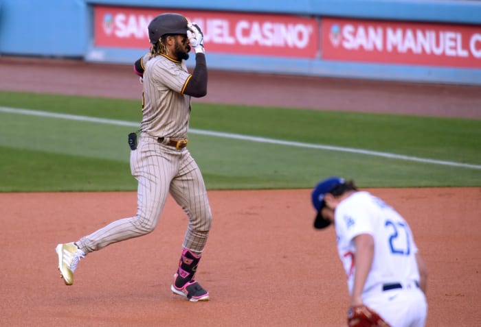 Fernando Tatis Jr. #23 of the San Diego Padres celebrates his solo homerun in front of Trevor Bauer