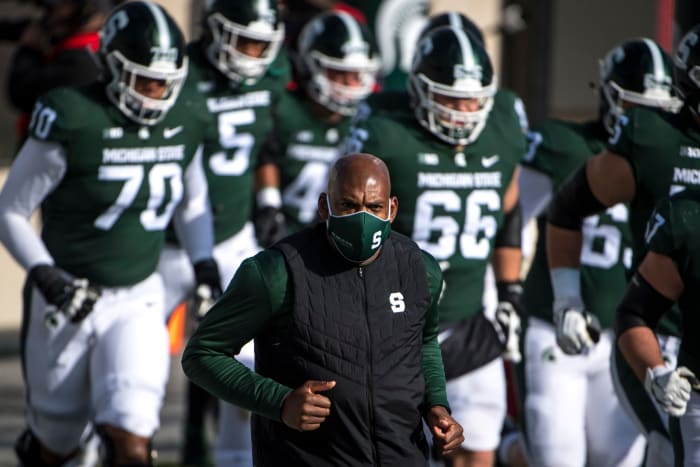Michigan State head coach Mel Tucker leads his team onto the field.