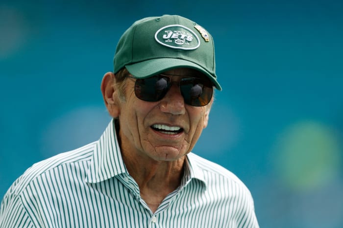 Joe Namath wearing a Jets hat.