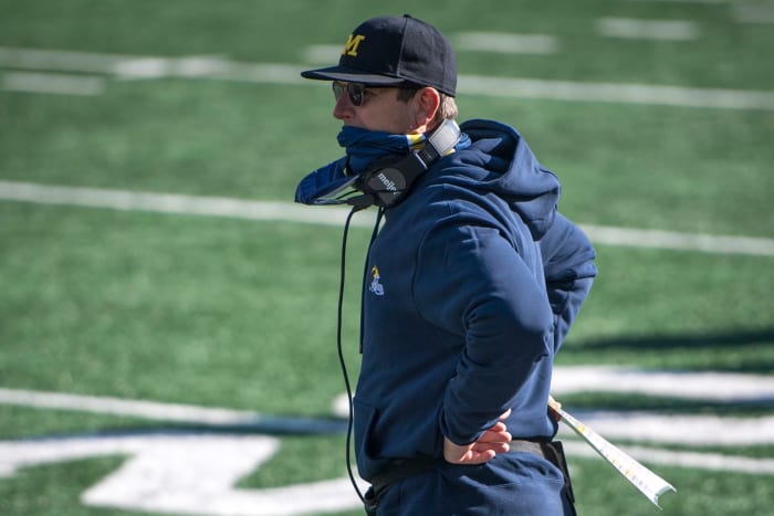 Michigan football head coach Jim Harbaugh on the bench.