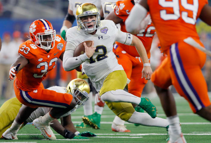 Notre Dame football quarterback Ian Book runs during Cotton Bowl against ACC power Clemson in a College Football Playoff game.