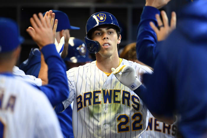 Christian Yelich celebrating in the dugout.