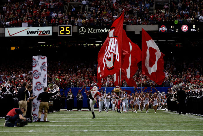 Ohio State Cheerleaders running onto the football field.