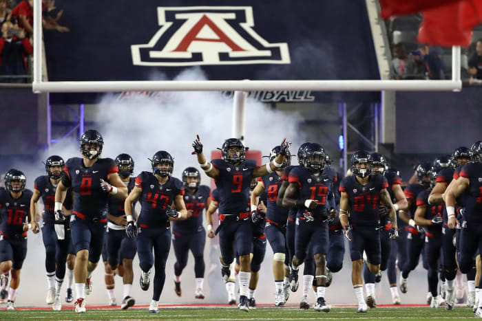 Arizona football players take the field.