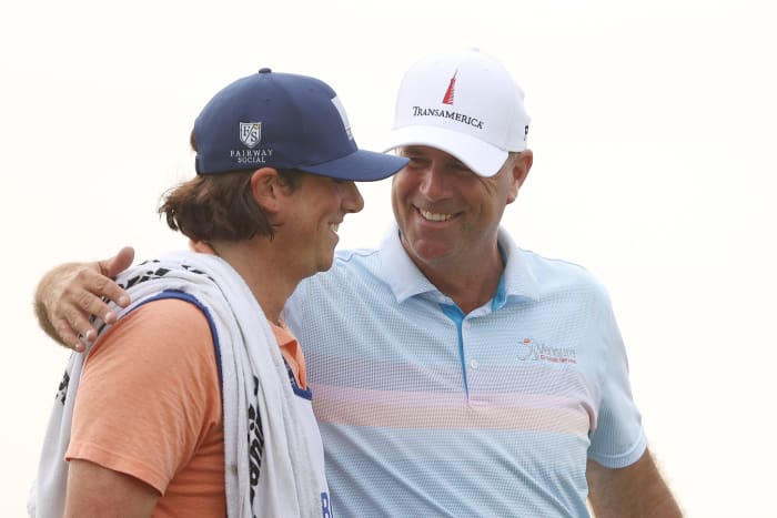 Stewart Cink of the United States celebrates with his caddie and son, Reagan Cink, on the 18th green after winning the RBC Heritage