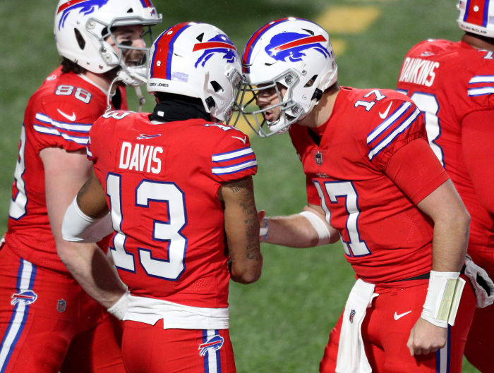 Josh Allen and Gabriel Davis celebrate on the field.