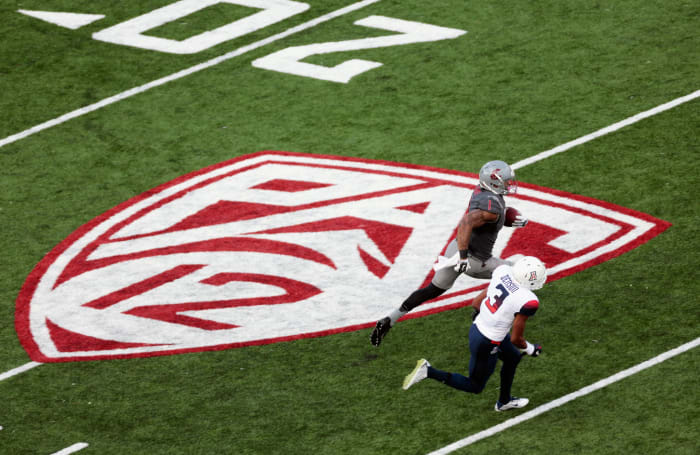 Washington State player looks to avoid an Arizona defender.