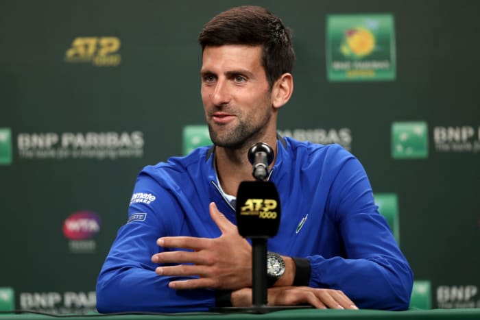 A closeup of Novak Djokovic speaking to the media.