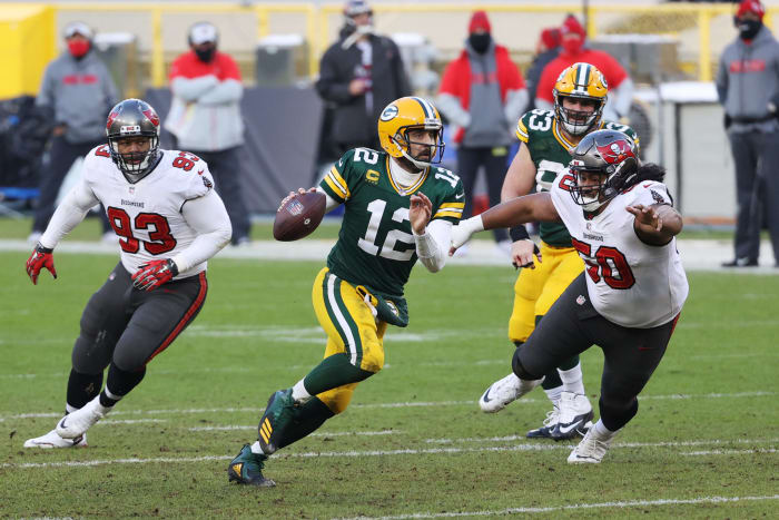 Aaron Rodgers runs with the football.