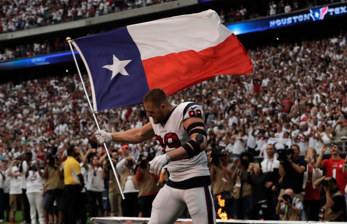 J.J. Watt running onto the field with the Texas State flag.