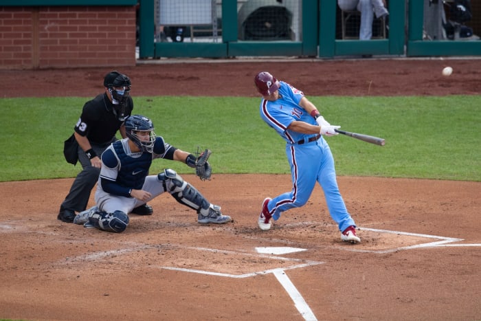 Phillies catcher J.T. Realmuto hits a home run in a game.