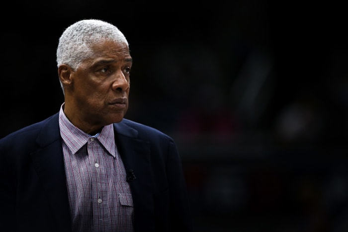 Julius Erving looks on during a basketball game.