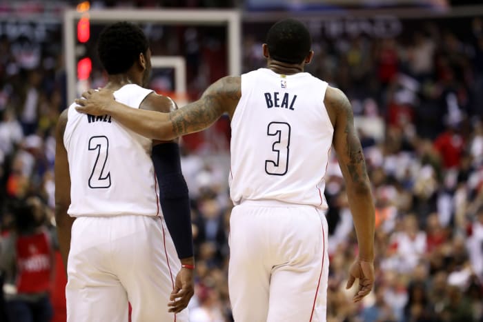 Washington Wizards star Bradley Beal putting his arm around John Wall during a game