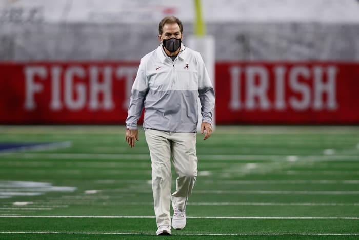 Nick Saban walks across the field.