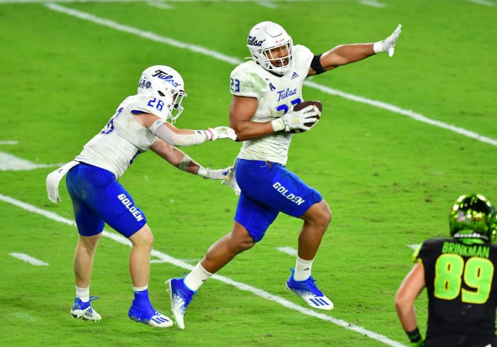 TAMPA, FLORIDA - OCTOBER 23: Zaven Collins #23 of the Tulsa Golden Hurricane celebrates after intercepting Noah Johnson #0 of the South Florida Bulls and running in a 38-yard touchdown during the third quarter at Raymond James Stadium on October 23, 2020 in Tampa, Florida. (Photo by Julio Aguilar/Getty Images)