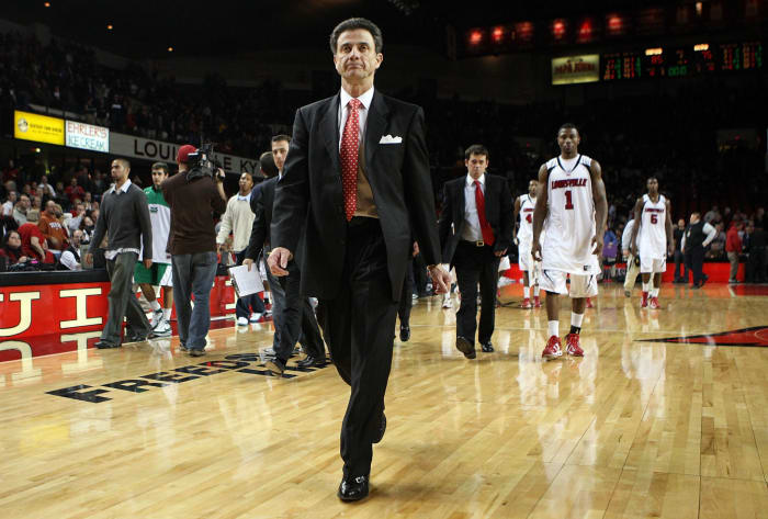 Rick Pitino walks off the floor with the Louisville basketball team.