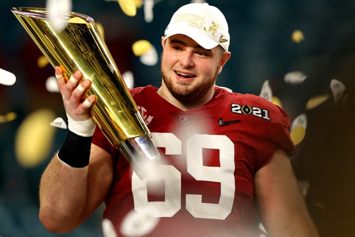 Landon Dickerson holds the CFP trophy.