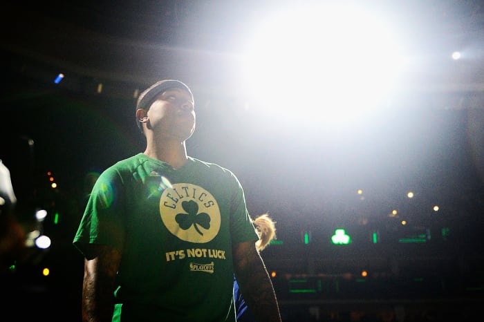 Isaiah Thomas wearing a green celtics t-shirt.