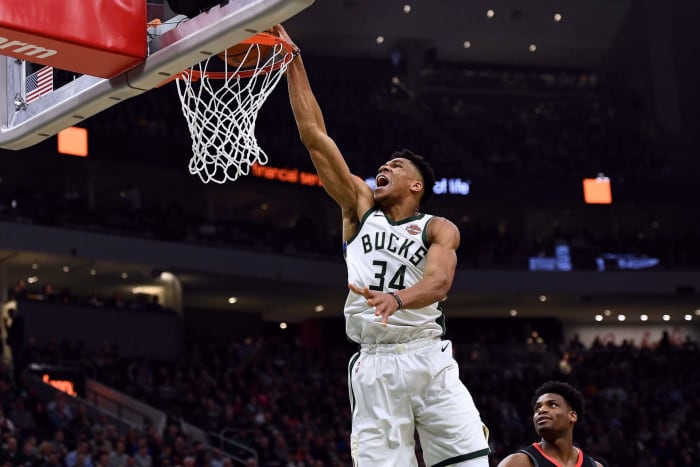 Giannis Antetokounmpo dunking the ball.