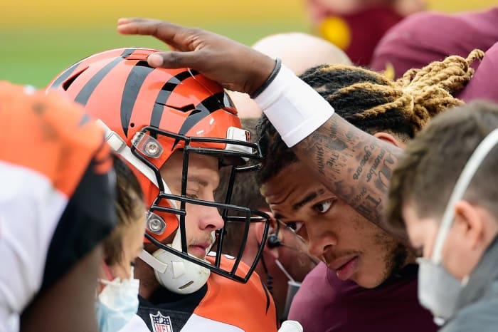Joe Burrow gets consoled by Chase Young after his injury.